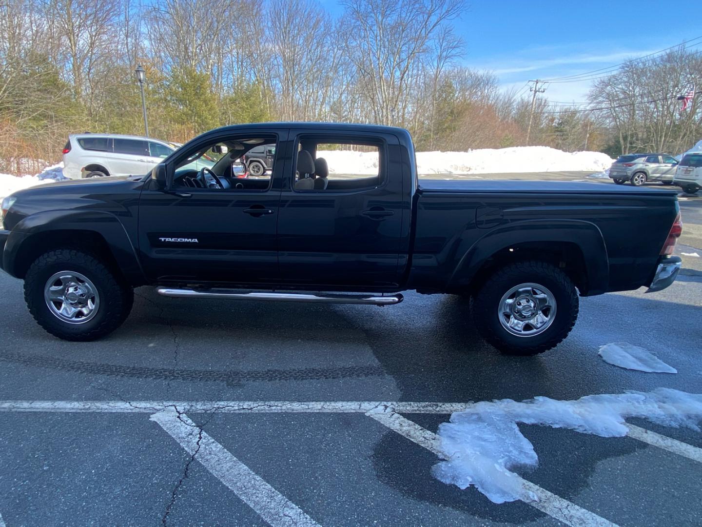 2007 BLACK /Tan Toyota Tacoma Double Cab Long Bed V6 Auto 4WD (5TEMU52N57Z) with an 4.0L V6 DOHC 24V engine, 5-Speed Automatic Overdrive transmission, located at 215 Milton St, Dedham, MA, 02026, (781) 329-5144, 42.241905, -71.157295 - Introducing this sleek Black 2007 Toyota Tacoma! This rugged beauty is the perfect blend of style, versatility, and reliability. With its powerful engine and 4WD/AWD capabilities, this truck is ready to conquer any road ahead. The deep tinted glass adds a touch of mystery while keeping you cool on t - Photo#4