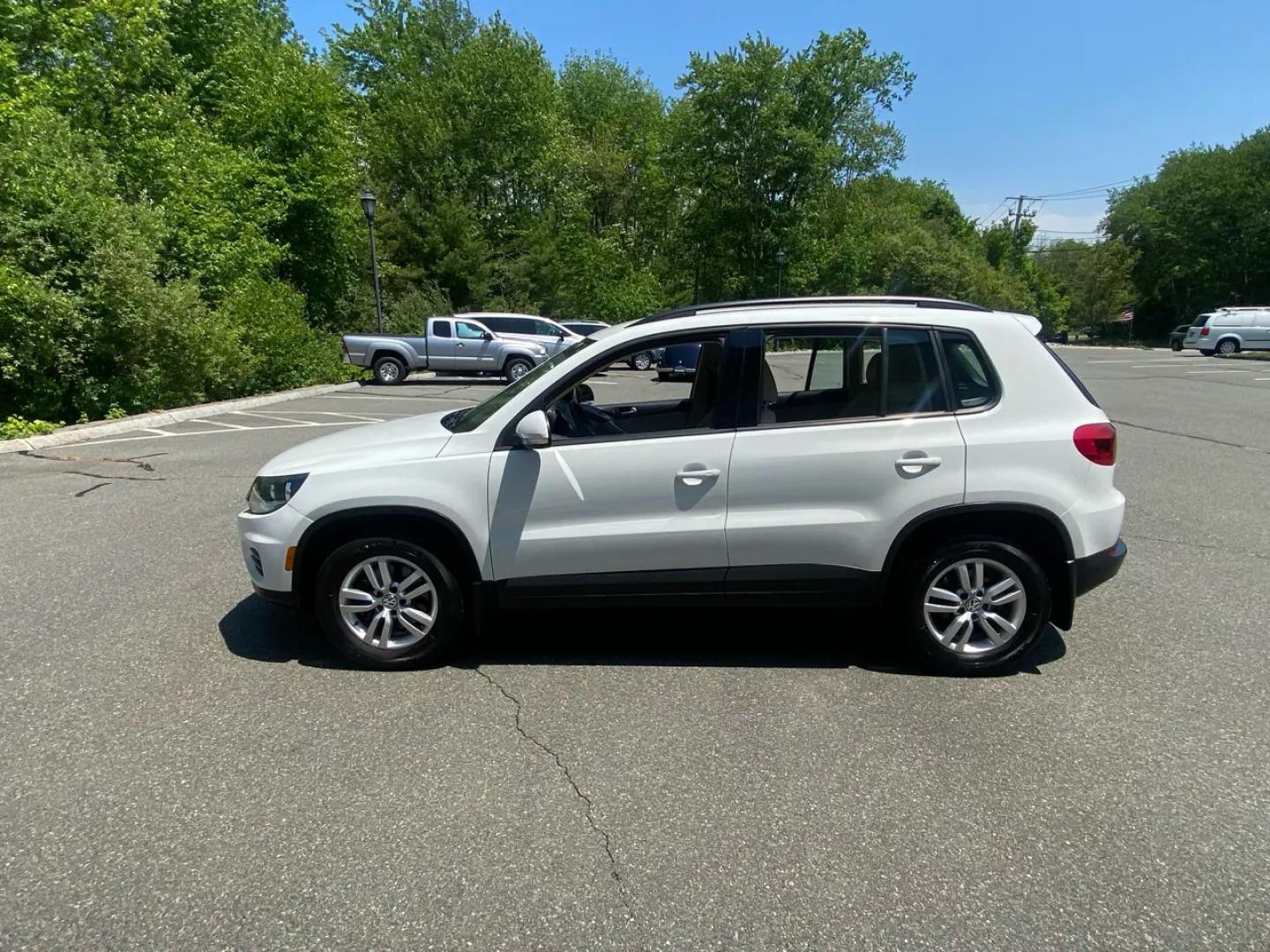 2016 White /Tan Volkswagen Tiguan SE 4Motion (WVGBV7AX5GW) with an 2.0L L4 DOHC 16V TURBO engine, 6A transmission, located at 215 Milton St, Dedham, MA, 02026, (781) 329-5144, 42.241905, -71.157295 - Hop into this sporty 2016 Volkswagen Tiguan and get ready for an adventure! With sleek white exterior and stylish alloy wheels, this car is sure to turn heads as you cruise down the road. You can rest easy knowing that safety is a top priority with features like ABS brakes, traction control, and mul- Photo#4