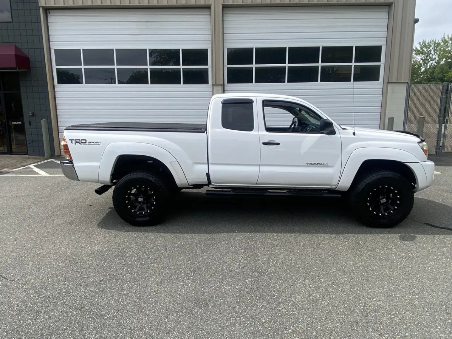 2011 White /Tan Toyota Tacoma Access Cab V6 4WD (5TFUU4EN8BX) with an 4.0L V6 DOHC 24V engine, 5M transmission, located at 215 Milton St, Dedham, MA, 02026, (781) 329-5144, 42.241905, -71.157295 - Get ready to hit the road in this rugged and reliable 2011 Toyota Tacoma! This white beauty is equipped with all the essentials to make your driving experience smooth and secure. From the powerful anti-lock braking system to the stability control system, you can drive with confidence knowing that yo- Photo#2